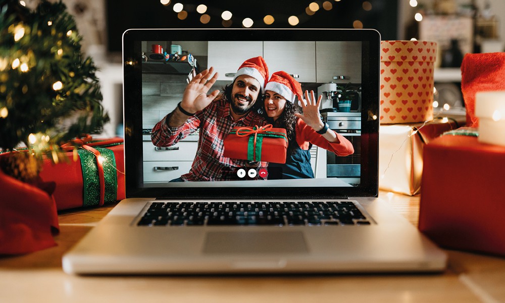 man and woman waving on screen in festive clothing