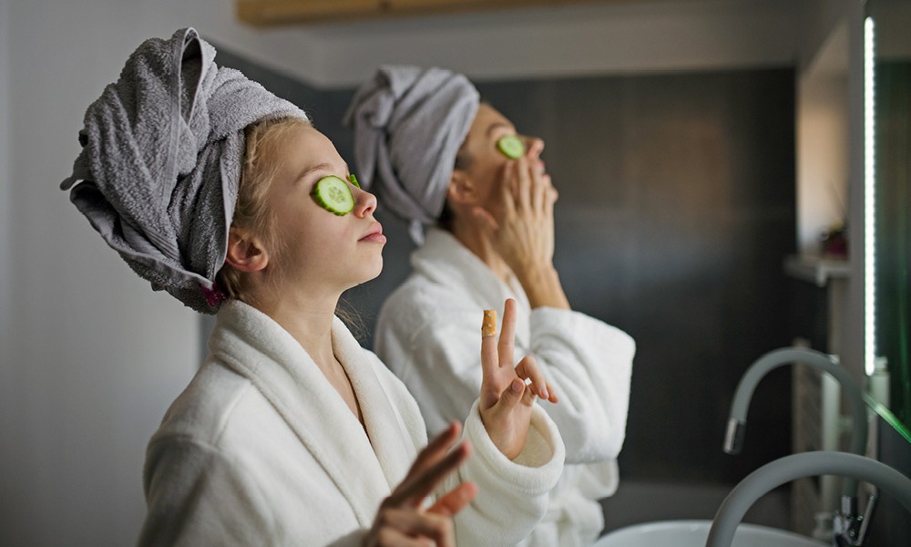 Woman and daughter in bathroom having a spa day